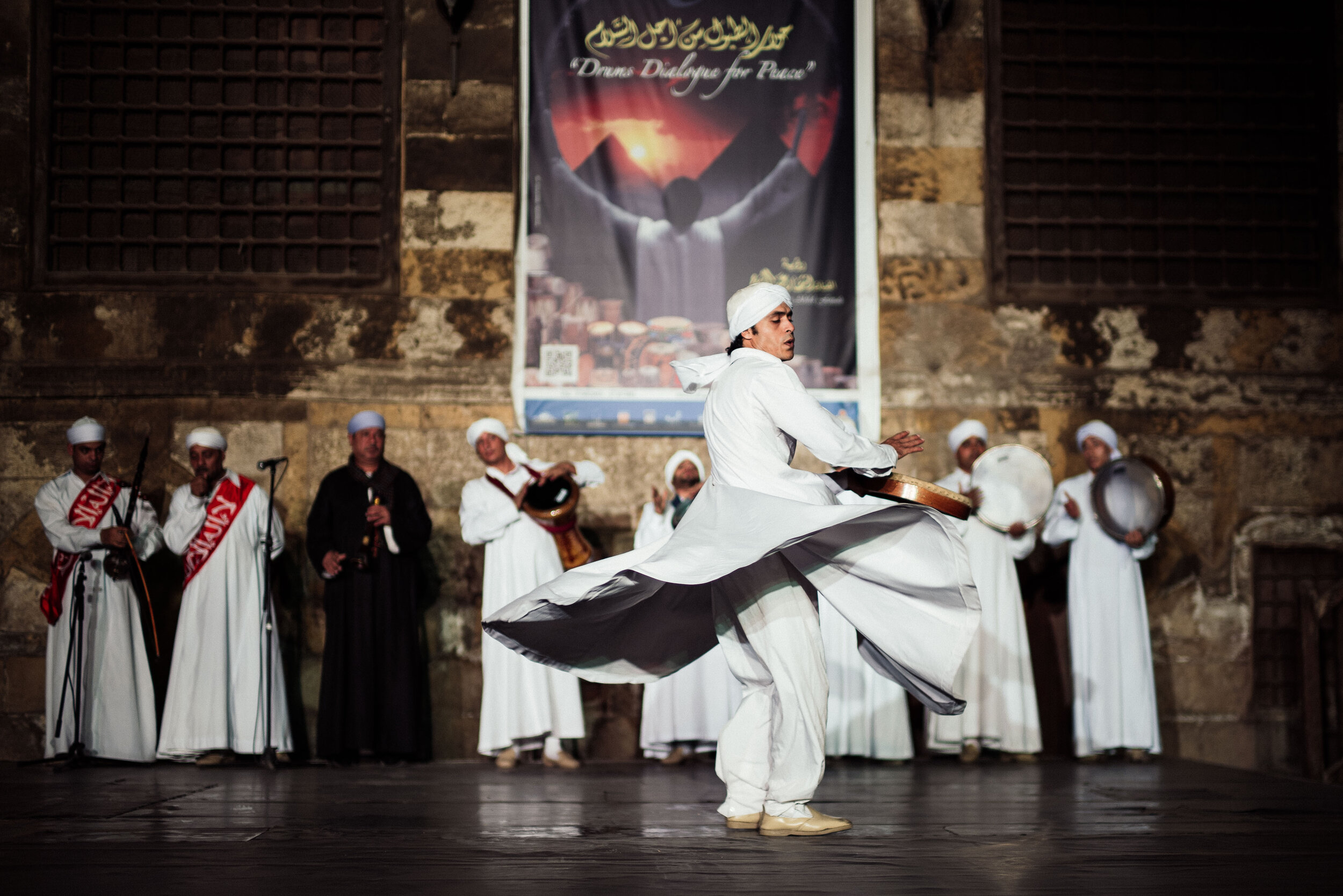 These Whirling Dervishes believe in performing their dhikr (an Islamic devotional act in which prayers are repeatedly recited within the mind or aloud) in the form of a dance which involves whirling.

This dance represents a mystical journey of man's spiritual ascent through mind and love to the "Perfect". Turning, the follower grows through love, deserts his ego, and finds truth. He then returns from this spiritual journey as a man who has reached maturity and a greater perfection, able to love and to be of service to the whole of creation.